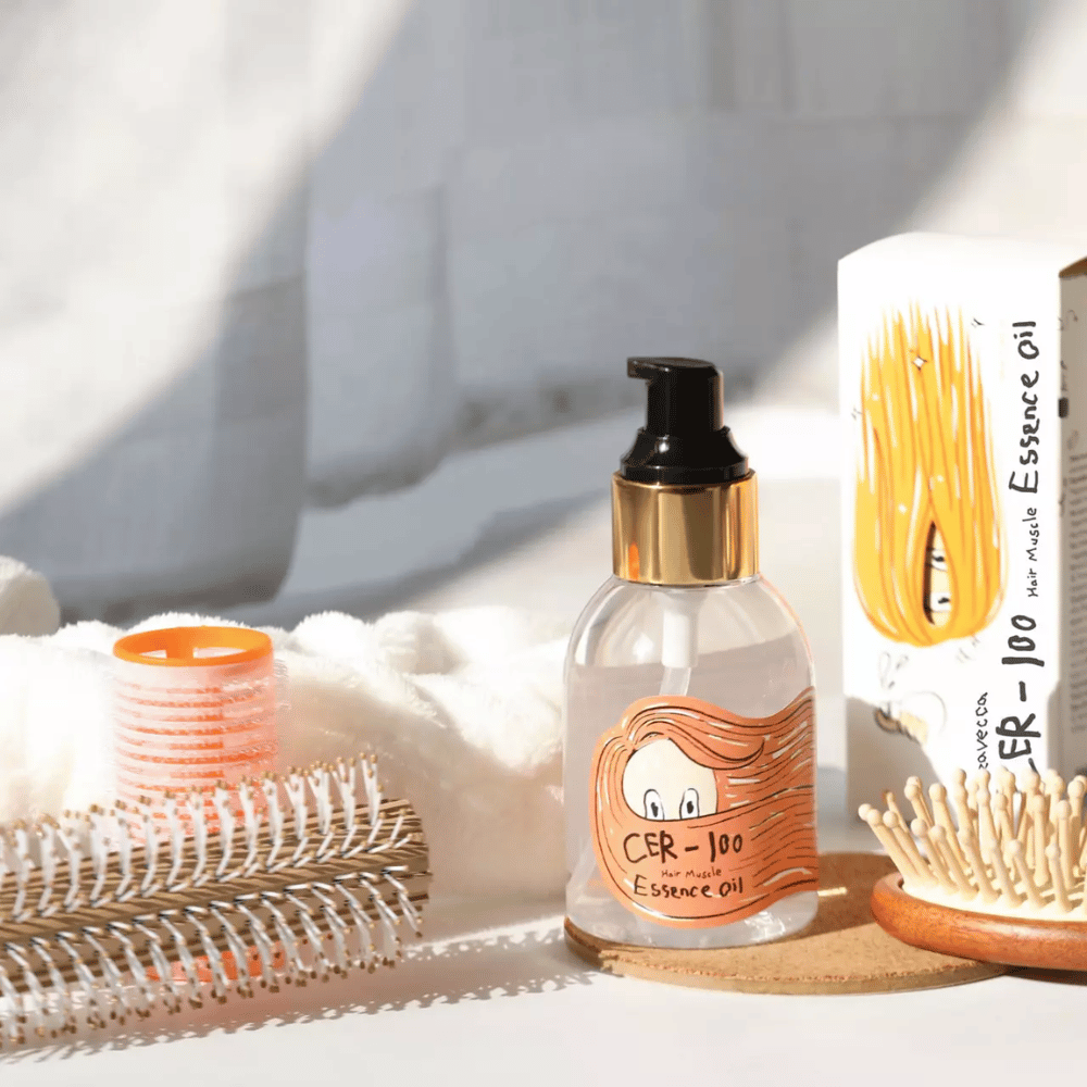 Elizavecca CER-100 Hair Muscle Essence Oil styling – hydraterende haarolie die helpt kroezen te verminderen, glans te geven en het haar te beschermen tijdens het stylen.
