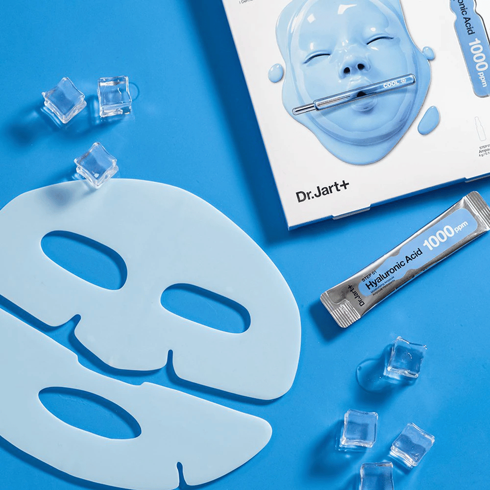 Dr.Jart+ Cryo Rubber Moisturizing Mask met tweedelig blauw rubbermasker, ijsblokjes, hyaluronzuurampul en verpakking tegen blauwe achtergrond.