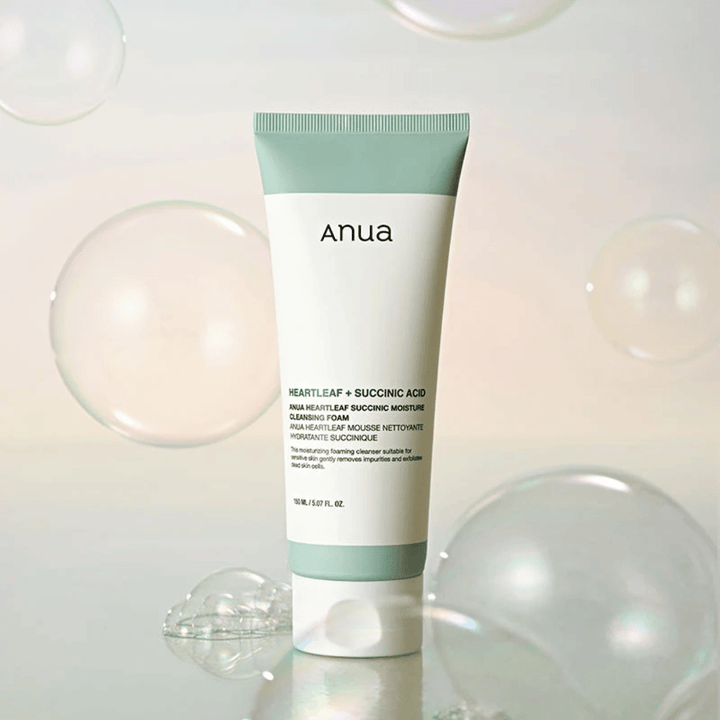 Productafbeelding van Anua Heartleaf + Succinic Acid Moisture Cleansing Foam omringd door transparante bubbels. De afbeelding versterkt het gevoel van milde reiniging, frisheid en luchtig schuim.