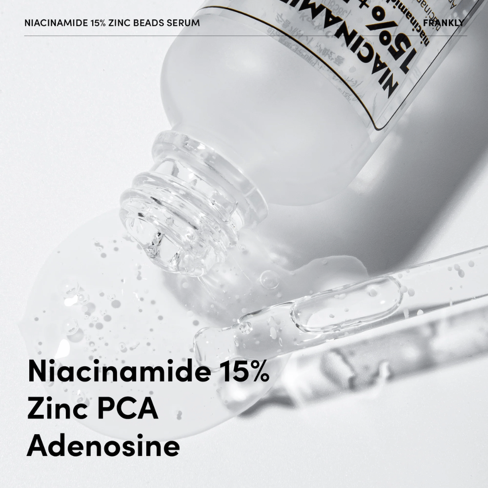 Close-up van FRANKLY Niacinamide 15% + Zinc Beads Serum dat wordt uitgegoten. Tekst toont ingrediënten: Niacinamide 15%, Zinc PCA en Adenosine.
