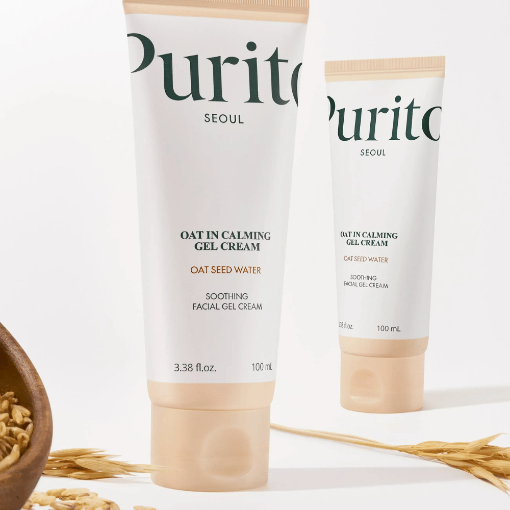 Purito Oat-In Calming Gel Cream in beige tube, geplaatst met haverkorrels. Kalmeert de gevoelige huid met haverwater en lichte geltextuur.