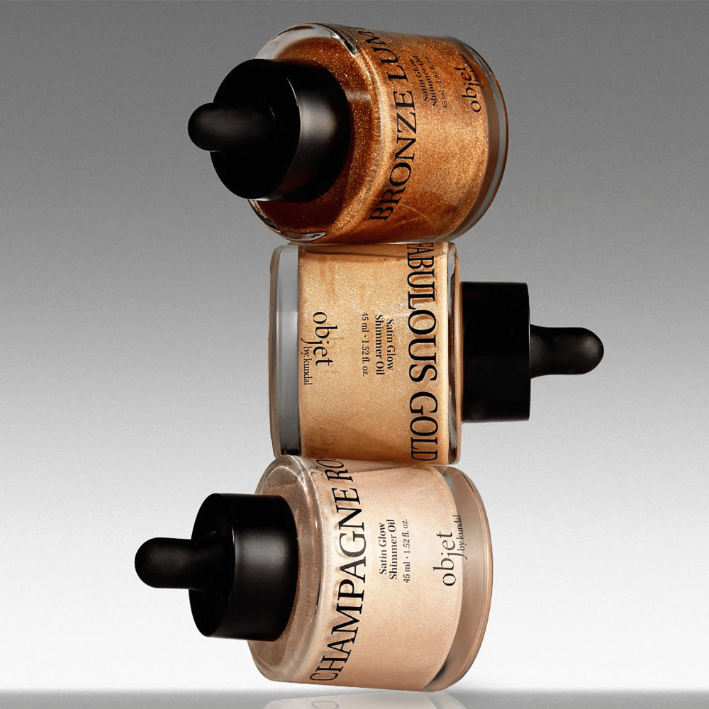 Objet by KUNDAL Satin Glow Shimmer Oil in Bronze Lumière, Fabulous Gold en Champagne Rose – glinsterende lichaamsoliën met een glansgevende finish.