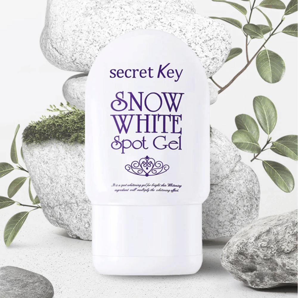 Secret Key Snow White Spot Gel gefotografeerd tegen stenen en groene bladeren.