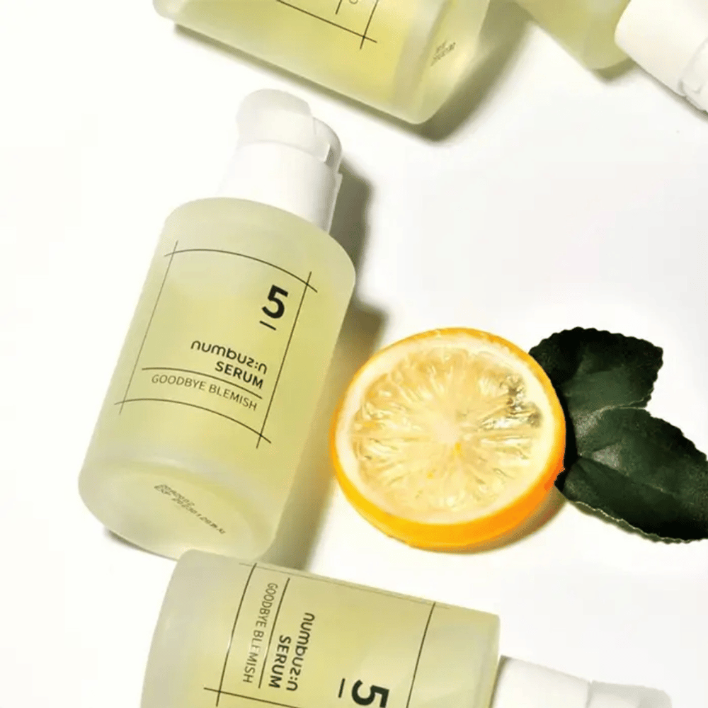 Vijf flessen numbuzin No.5 Goodbye Blemish Serum 50ml met citroenen en bladeren die zich richten op vlekken en acnelittekens.