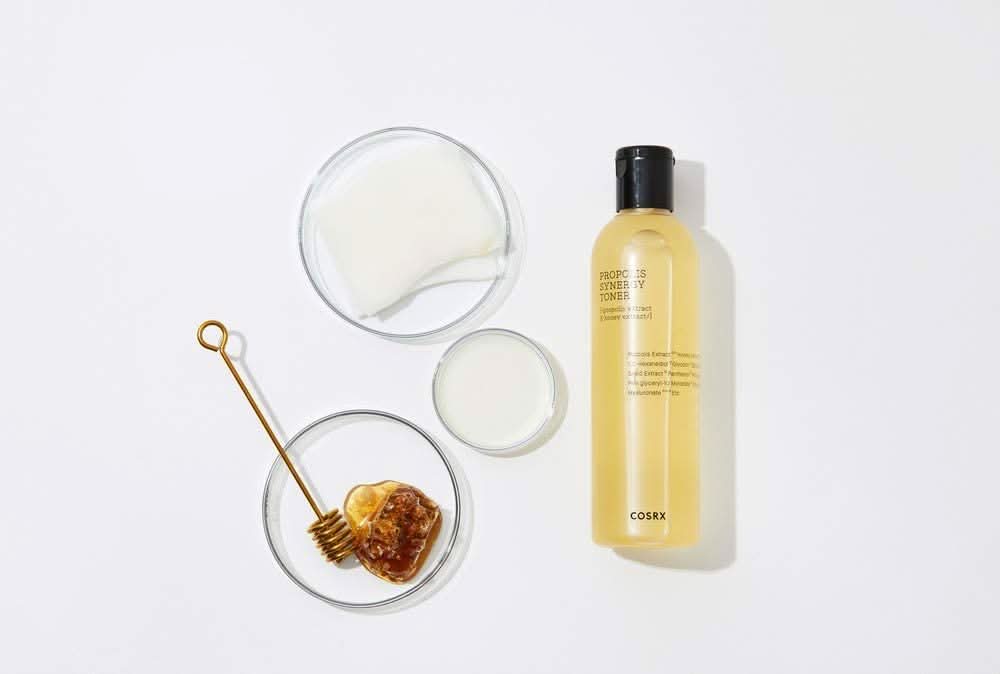 Een fles COSRX Full Fit Propolis Synergy Toner 150ml met ontstekingsremmende en antibacteriële effecten, geplaatst op een wit oppervlak.