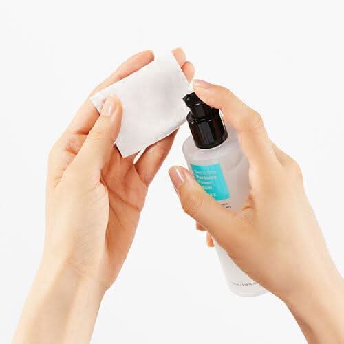 Een hand die het gebruik van COSRX Two In One Poreless Power Liquid 100ml voor vette huid laat zien.
